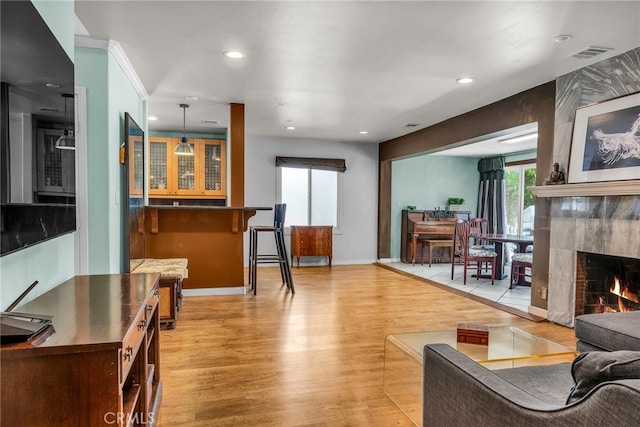17508 Strathern St, Northridge, CA 91325 - living area with light wood finished floors, a tiled fireplace, recessed lighting, and baseboards