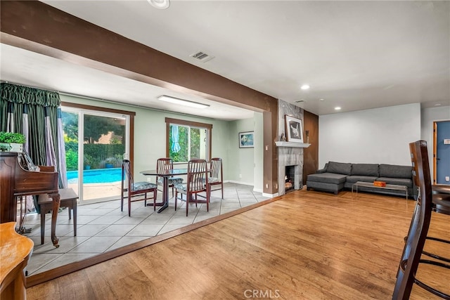 17508 Strathern St, Northridge, CA 91325 - dining room featuring wood finished floors, a tiled fireplace, recessed lighting, and baseboards