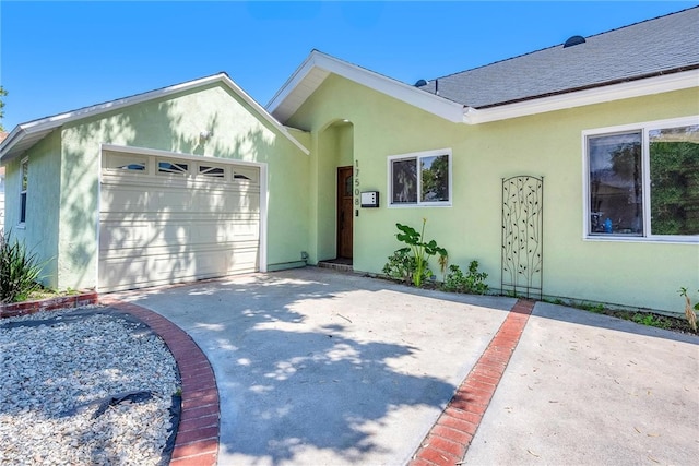 17508 Strathern St, Northridge, CA 91325 - view of front of house featuring driveway, an attached garage, stucco siding, and roof with shingles