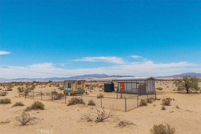 84951 Amboy Rd Unit 29, Palms, CA 92277 - view of front of home with a mountain view, a desert view, an outdoor structure, and a view of countryside