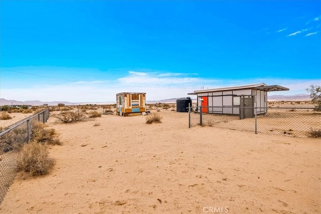 84951 Amboy Rd Unit 29, Palms, CA 92277 - view of yard with a mountain view, an outbuilding, and a view of countryside