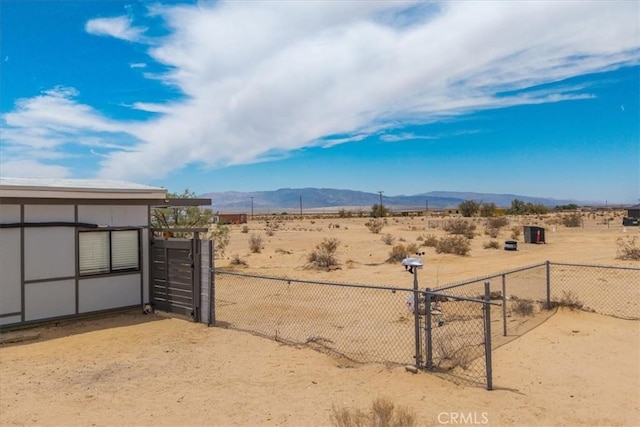 84951 Amboy Rd Unit 29, Palms, CA 92277 - view of yard with a mountain view, a rural view, a gate, and view of desert landscape