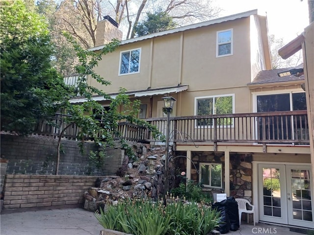 23304 Crest Forest Dr, Crestline, CA 92325 - rear view of house with french doors, stucco siding, a chimney, and a patio area
