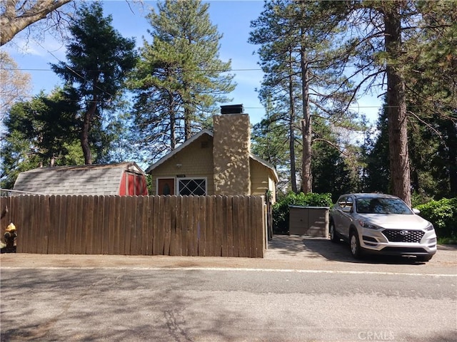 23304 Crest Forest Dr, Crestline, CA 92325 - view of side of home featuring a chimney