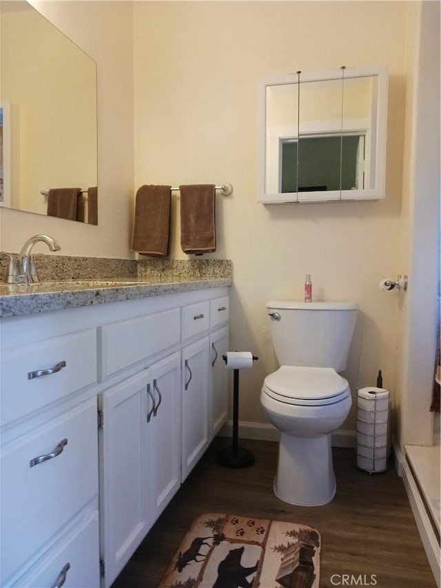 23304 Crest Forest Dr, Crestline, CA 92325 - bathroom featuring vanity, wood finished floors, toilet, and baseboards