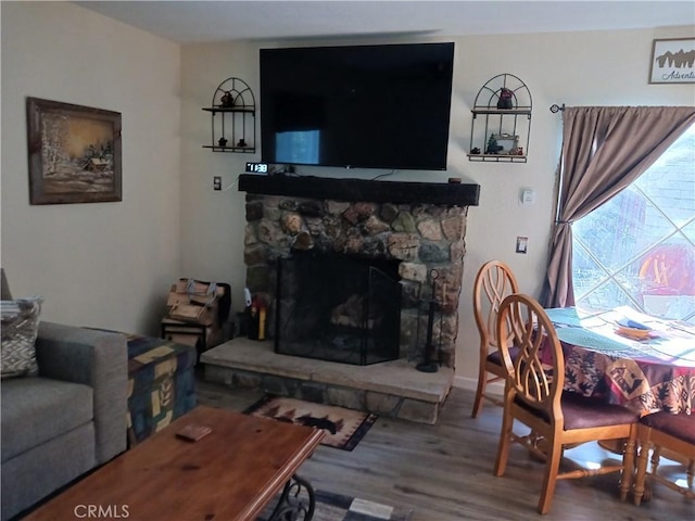 23304 Crest Forest Dr, Crestline, CA 92325 - living area with wood finished floors and a stone fireplace
