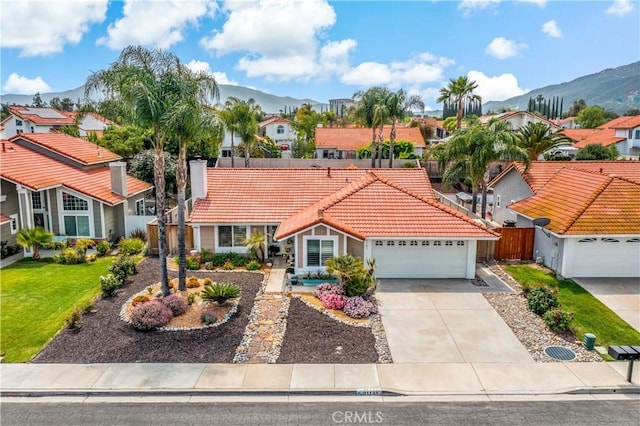 31141 Via Gilberto, Temecula, CA 92592 - view of front of home featuring a tiled roof, a mountain view, a residential view, an attached garage, and concrete driveway