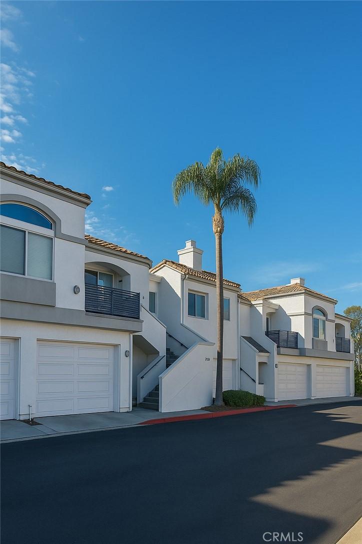 24982 La Pantera, Laguna Niguel, CA 92677 - view of front of home with stucco siding, a chimney, a tile roof, and an attached garage