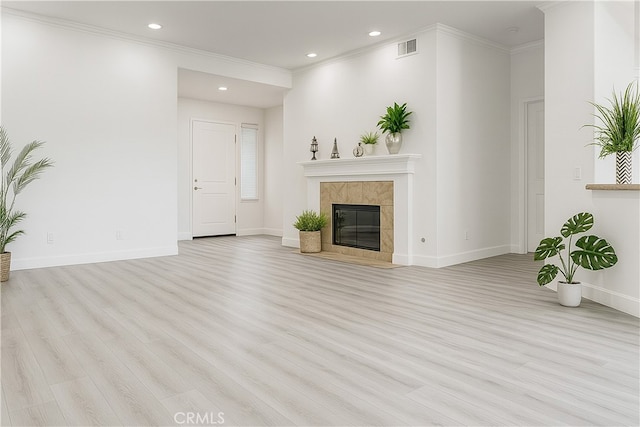 24982 La Pantera, Laguna Niguel, CA 92677 - unfurnished living room featuring light wood-style flooring, ornamental molding, a tiled fireplace, and recessed lighting