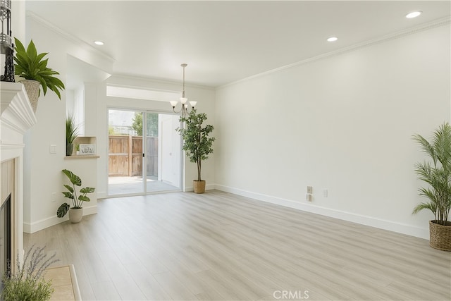 24982 La Pantera, Laguna Niguel, CA 92677 - unfurnished living room featuring a chandelier, light wood-style flooring, a fireplace, recessed lighting, and crown molding