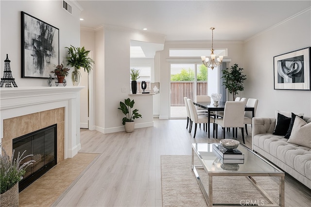 24982 La Pantera, Laguna Niguel, CA 92677 - living room with a chandelier, light wood finished floors, crown molding, a tile fireplace, and recessed lighting