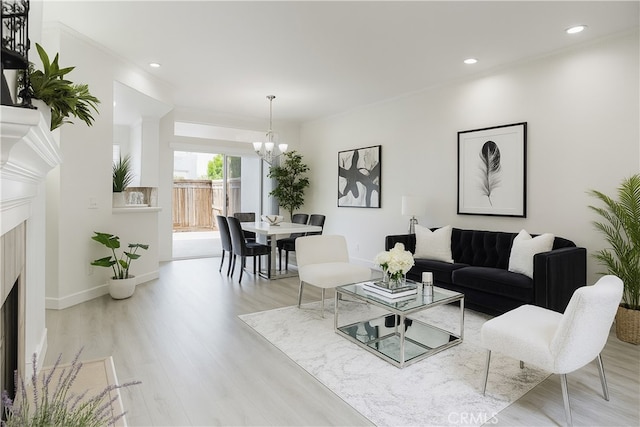 24982 La Pantera, Laguna Niguel, CA 92677 - living room with a chandelier, a high end fireplace, light wood finished floors, recessed lighting, and crown molding