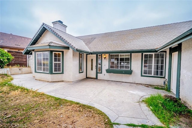 4496 Lyon Ave, Riverside, CA 92505 - view of front of house featuring a chimney, stucco siding, and a patio area