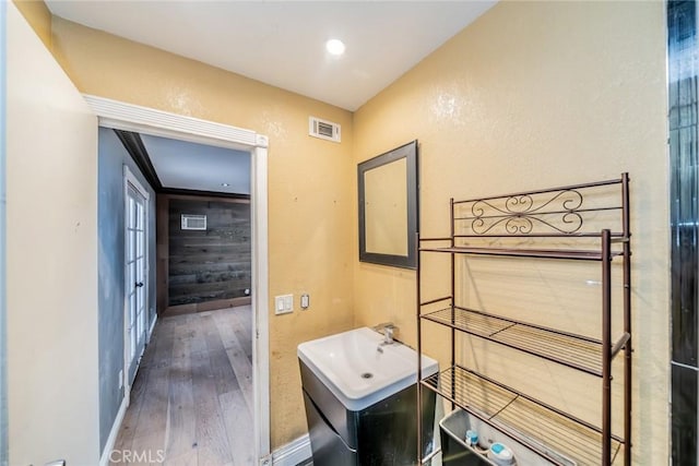 4496 Lyon Ave, Riverside, CA 92505 - bathroom featuring hardwood / wood-style floors, baseboards, recessed lighting, vanity, and french doors