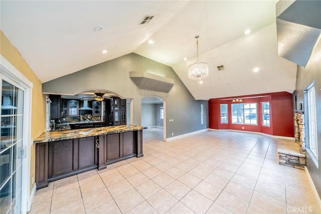 4496 Lyon Ave, Riverside, CA 92505 - kitchen with open floor plan, high vaulted ceiling, premium range hood, light tile patterned floors, and arched walkways