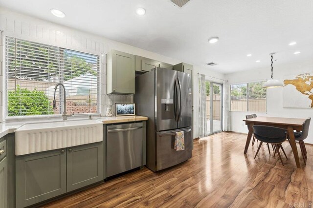 305 Cobblestone Pl, Santee, CA 92071 - kitchen with stainless steel appliances, a sink, dark wood finished floors, light countertops, and recessed lighting
