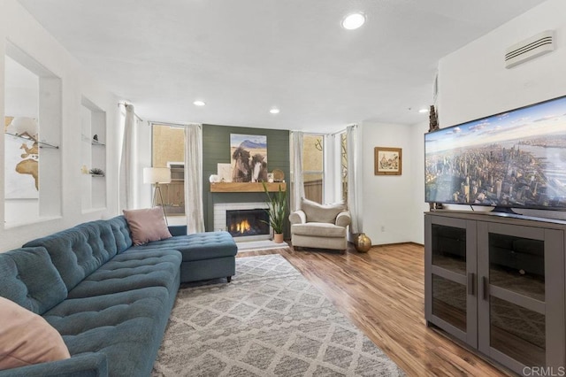 305 Cobblestone Pl, Santee, CA 92071 - living room with wood finished floors, a glass covered fireplace, and recessed lighting