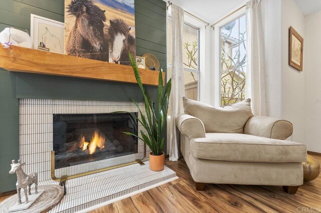 305 Cobblestone Pl, Santee, CA 92071 - sitting room with plenty of natural light, wood finished floors, and a lit fireplace