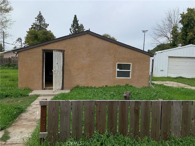 12933 Main St, Waterford, CA 95386 - view of front of house featuring stucco siding and an outbuilding