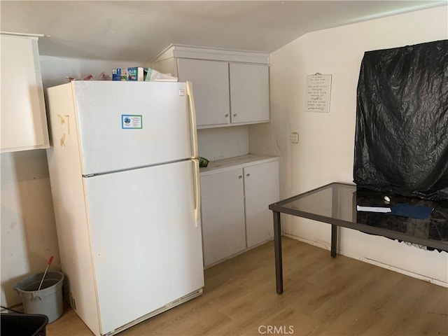 12933 Main St, Waterford, CA 95386 - kitchen featuring freestanding refrigerator, light wood finished floors, white cabinets, and light countertops