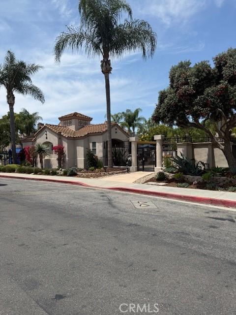 19 Softwind, Aliso Viejo, CA 92656 - mediterranean / spanish-style home with a gate, a tile roof, and stucco siding
