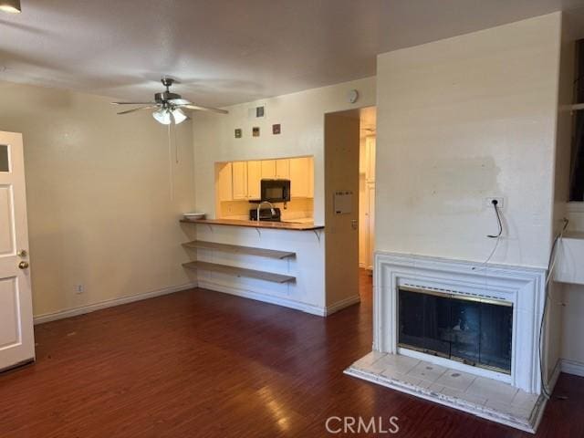19 Softwind, Aliso Viejo, CA 92656 - unfurnished living room featuring a ceiling fan and dark wood-style flooring