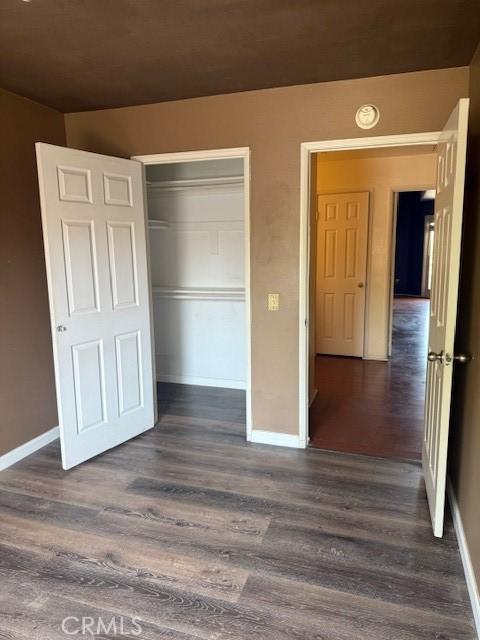 19 Softwind, Aliso Viejo, CA 92656 - unfurnished bedroom featuring dark wood-style flooring and a closet