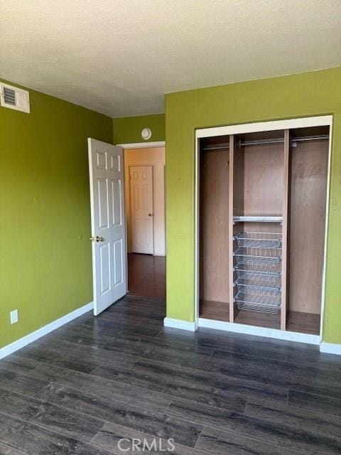 19 Softwind, Aliso Viejo, CA 92656 - unfurnished bedroom featuring dark wood-style flooring, a closet, and a textured ceiling