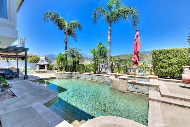 12 Thorn Oak, Rancho Santa Margarita, CA 92679 - view of pool featuring exterior fireplace, a patio area, a fenced backyard, a jacuzzi, and a mountain view