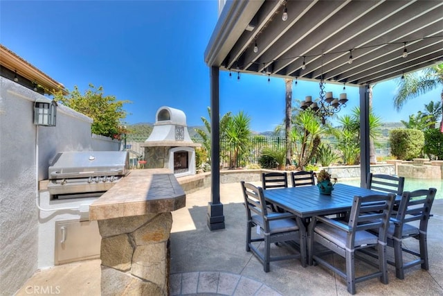 12 Thorn Oak, Rancho Santa Margarita, CA 92679 - view of patio / terrace with exterior fireplace, area for grilling, and outdoor dining area
