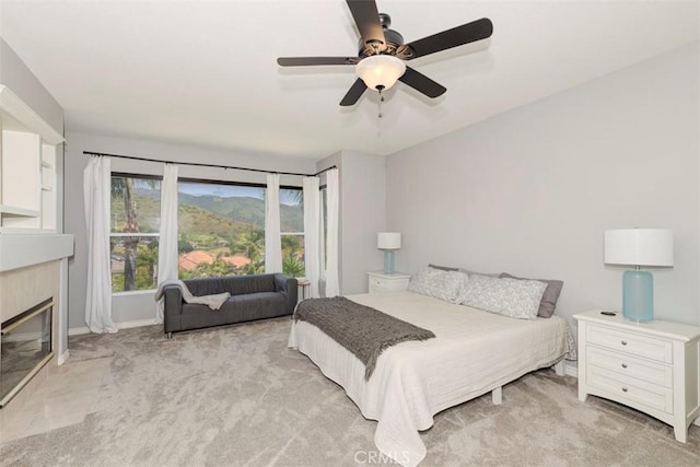 12 Thorn Oak, Rancho Santa Margarita, CA 92679 - bedroom featuring light colored carpet, a fireplace with flush hearth, a ceiling fan, and baseboards