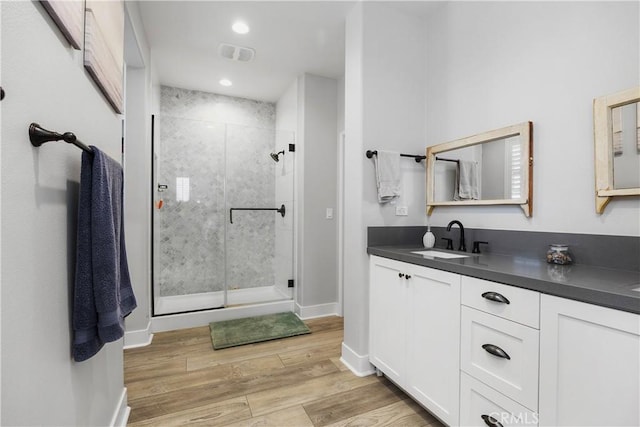 45437 Calle Cirros, Temecula, CA 92592 - bathroom featuring a stall shower, wood finished floors, double vanity, and recessed lighting