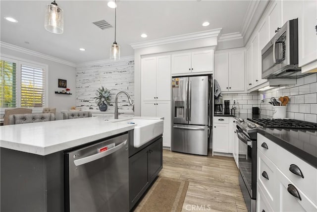 45437 Calle Cirros, Temecula, CA 92592 - kitchen featuring stainless steel appliances, crown molding, decorative backsplash, hanging light fixtures, and white cabinets