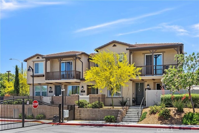 45437 Calle Cirros, Temecula, CA 92592 - view of front of property featuring stucco siding, a balcony, and a gate