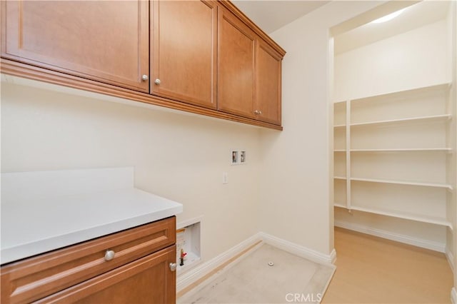 6611 Eucalyptus Ave, Chino, CA 91710 - laundry area featuring washer hookup, cabinet space, baseboards, and light wood finished floors