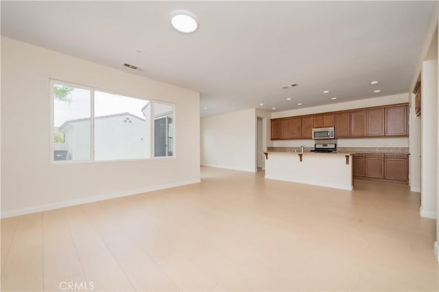 6611 Eucalyptus Ave, Chino, CA 91710 - unfurnished living room featuring baseboards and recessed lighting