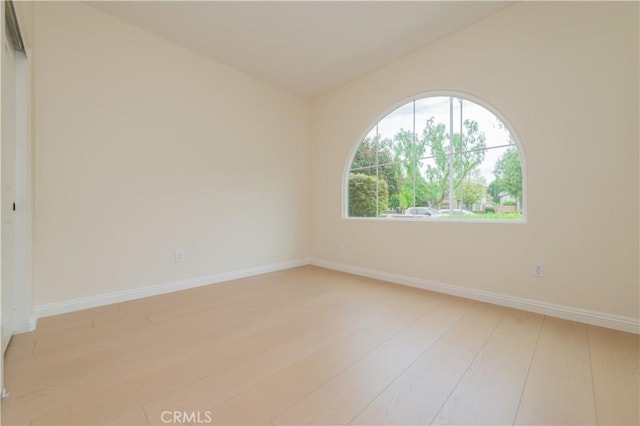 6611 Eucalyptus Ave, Chino, CA 91710 - empty room with light wood-style floors, baseboards, and vaulted ceiling