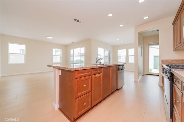 6611 Eucalyptus Ave, Chino, CA 91710 - kitchen with range with gas cooktop, a sink, dishwasher, brown cabinets, and recessed lighting