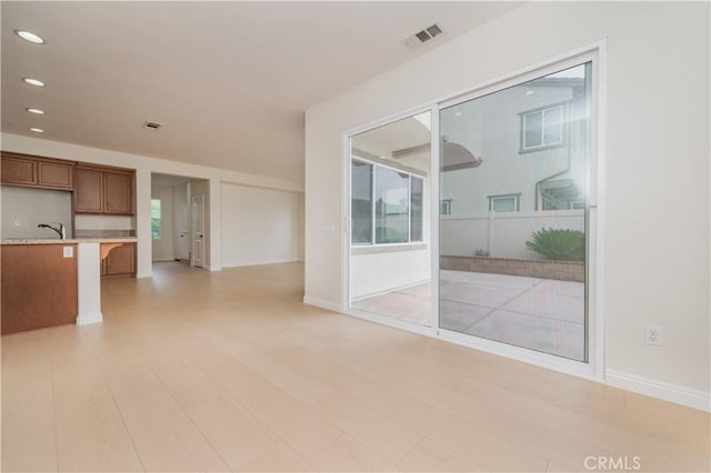 6611 Eucalyptus Ave, Chino, CA 91710 - empty room with recessed lighting, light wood-type flooring, baseboards, and a sink