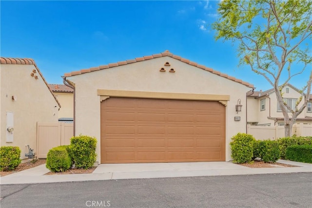 6611 Eucalyptus Ave, Chino, CA 91710 - view of front of home with stucco siding, a tile roof, and a garage