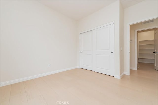 6611 Eucalyptus Ave, Chino, CA 91710 - unfurnished bedroom featuring a closet, baseboards, and light wood-style floors