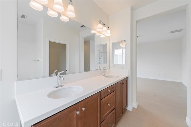 6611 Eucalyptus Ave, Chino, CA 91710 - bathroom with double vanity, baseboards, and wood finished floors