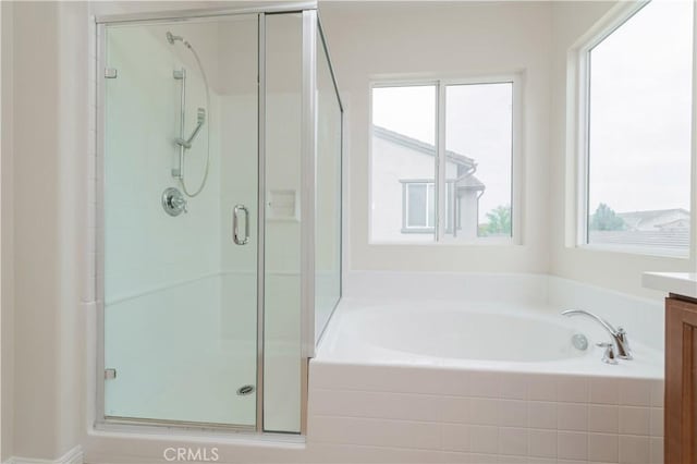 6611 Eucalyptus Ave, Chino, CA 91710 - bathroom featuring vanity, a stall shower, a bath, and plenty of natural light