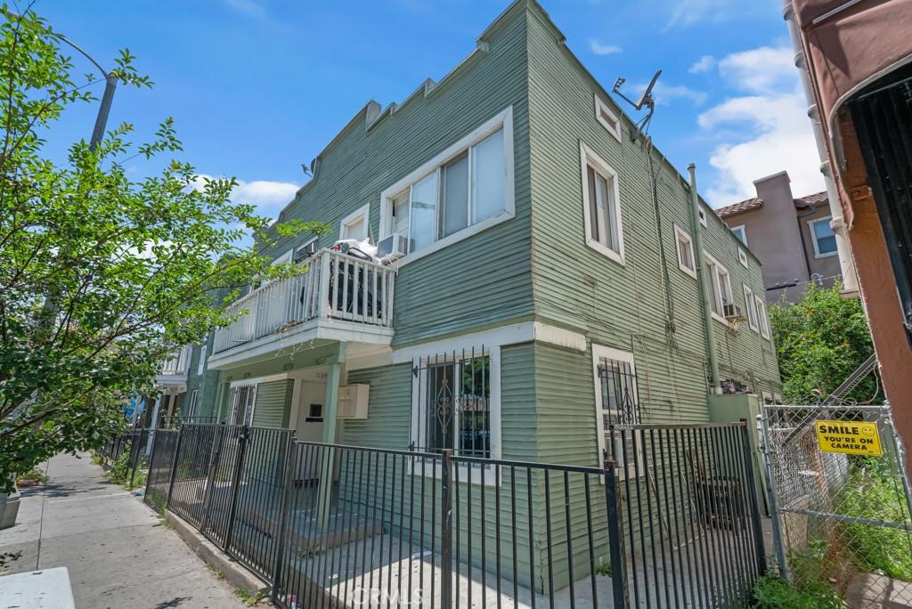 1137 S Union Ave, Los Angeles, CA 90015 - view of home's exterior with a gate, a fenced front yard, and a balcony