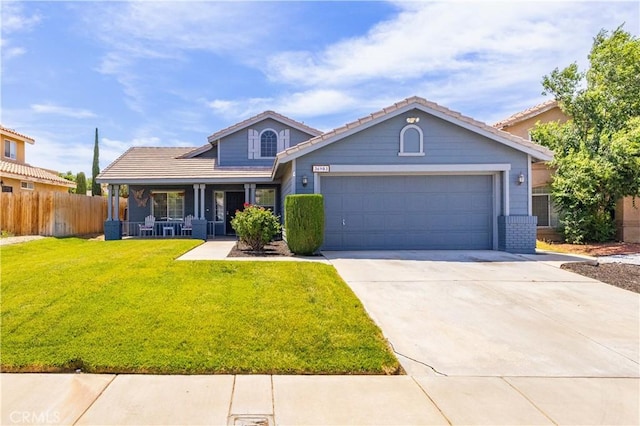 36903 Firethorn St, Palmdale, CA 93550 - view of front facade with a porch, a garage, concrete driveway, and a tile roof
