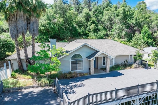 54326 Wildwood Springs Trl, North Fork, CA 93643 - ranch-style home featuring a chimney, a wooden deck, and roof with shingles