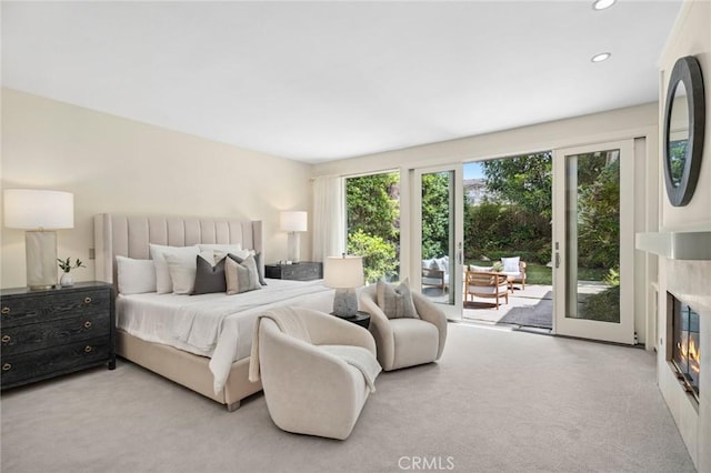 6 Rue Marseilles, Newport Beach, CA 92660 - bedroom with access to outside, a glass covered fireplace, carpet floors, and recessed lighting