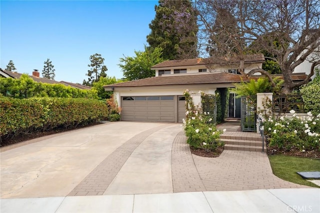 6 Rue Marseilles, Newport Beach, CA 92660 - view of front of property featuring concrete driveway, stucco siding, and a garage