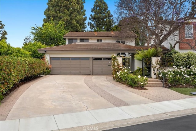 6 Rue Marseilles, Newport Beach, CA 92660 - view of front of home with driveway, a tiled roof, and stucco siding