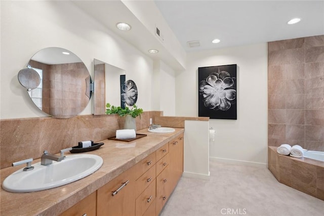 6 Rue Marseilles, Newport Beach, CA 92660 - bathroom with double vanity, tiled tub, recessed lighting, backsplash, and baseboards